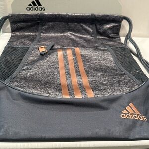 NWT Adidas Athletic Pull string bag with side and front pockets.